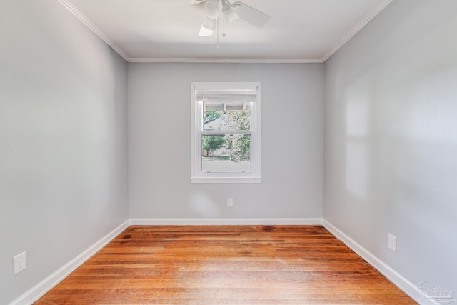 empty room with baseboards, light wood-style floors, and ornamental molding