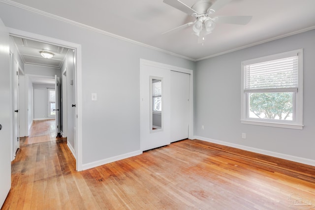 unfurnished room with light wood-type flooring, crown molding, baseboards, and a ceiling fan