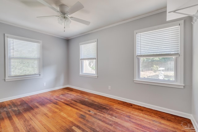 unfurnished room with ornamental molding, ceiling fan, baseboards, and hardwood / wood-style flooring