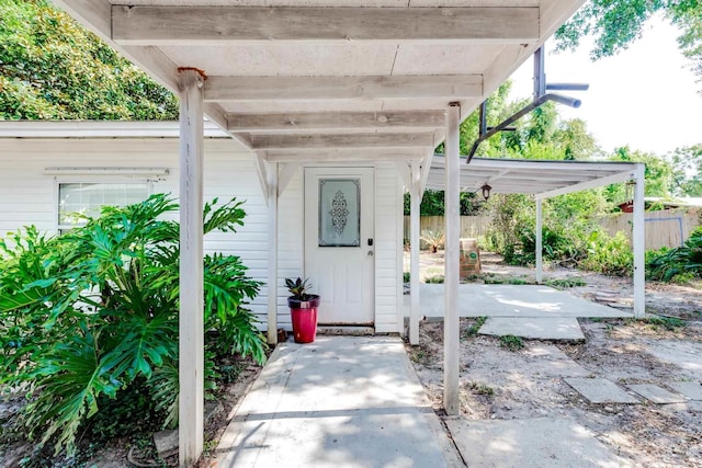 property entrance featuring a patio area and fence