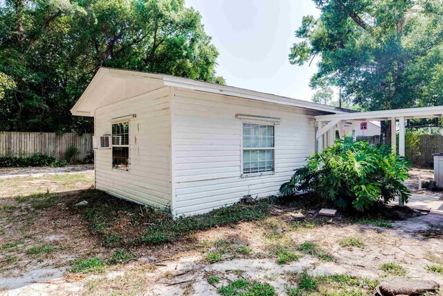 view of home's exterior with fence