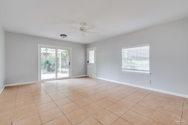 unfurnished room featuring baseboards and ceiling fan