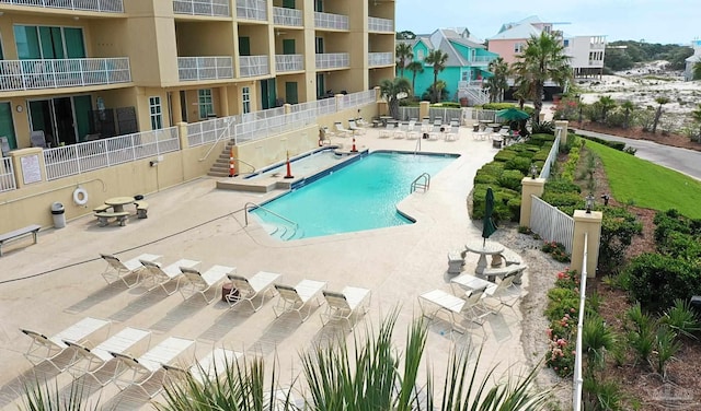 pool featuring fence and a patio