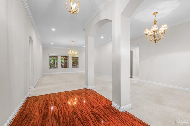 1061 Black Walnut Trl, Pensacola, FL 32514 - entryway with a chandelier, arched walkways, ornamental molding, light colored carpet, and baseboards