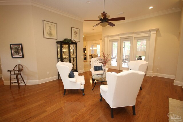 living room with baseboards, recessed lighting, wood finished floors, ceiling fan, and crown molding