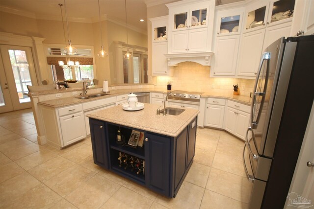 kitchen with crown molding, stainless steel appliances, white cabinetry, and a sink