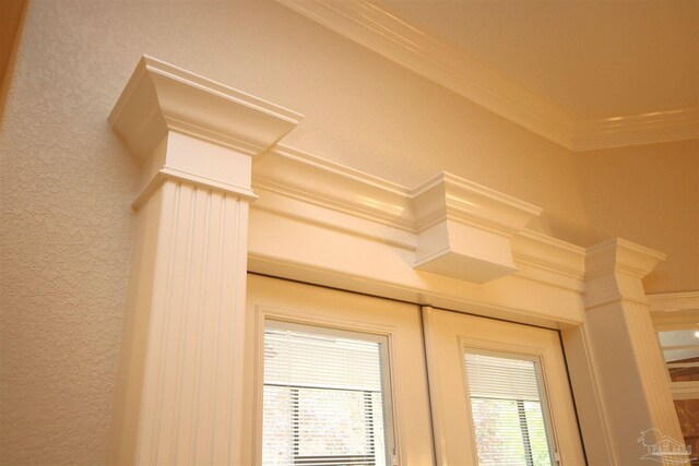 interior details with a textured wall and ornamental molding