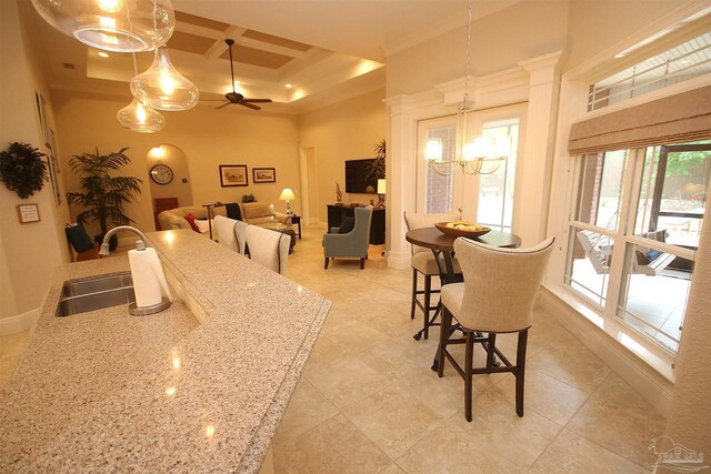 dining room featuring coffered ceiling, light tile patterned floors, crown molding, baseboards, and ceiling fan with notable chandelier