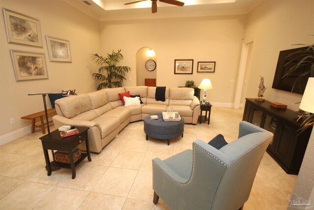 living area with a ceiling fan, baseboards, light tile patterned floors, and crown molding