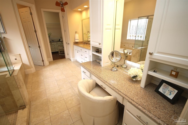 bathroom featuring a bath, a shower stall, tile patterned flooring, and a closet