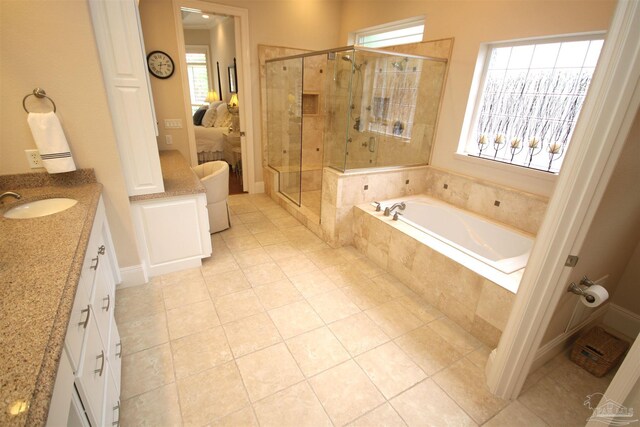 bathroom featuring tile patterned flooring, a shower stall, ensuite bath, and a garden tub