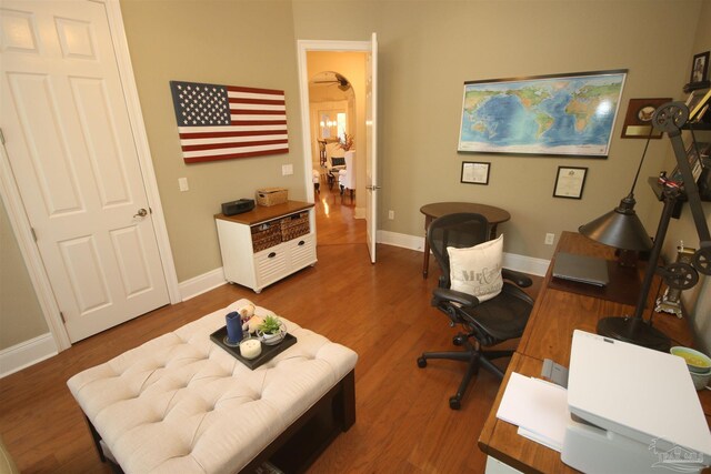 home office featuring wood finished floors and baseboards
