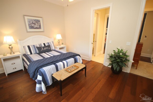 bedroom with wood finished floors and baseboards