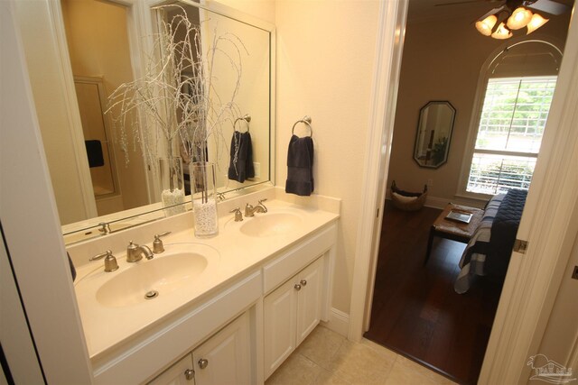 bathroom with double vanity, tile patterned floors, ceiling fan, and a sink