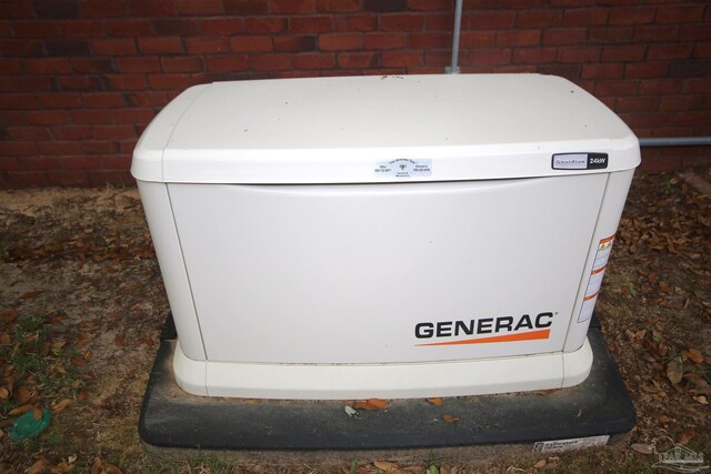 exterior details featuring brick siding and a power unit