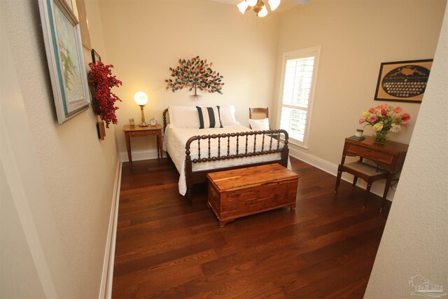 bedroom with baseboards and dark wood-style floors