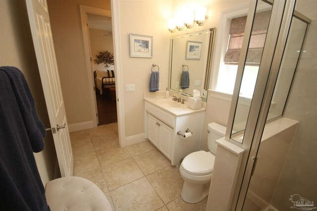 bathroom featuring vanity, toilet, a stall shower, and tile patterned floors