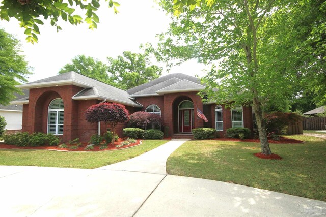 view of front of home with brick siding and a front yard