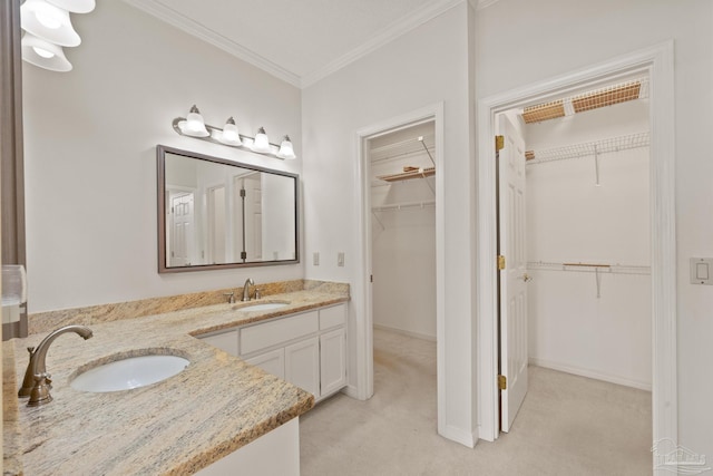 bathroom featuring crown molding and vanity