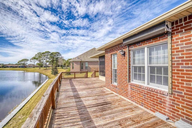 wooden terrace featuring a water view