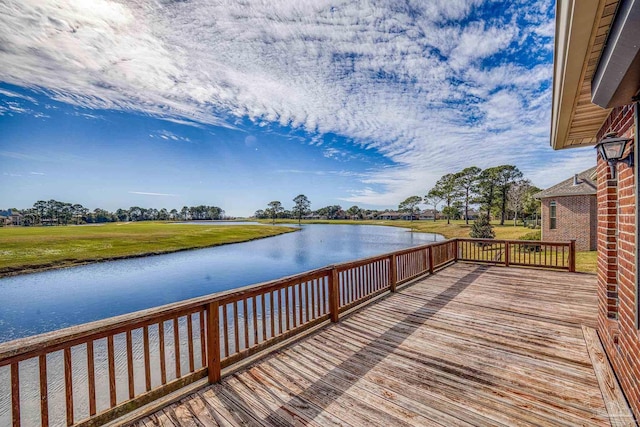 exterior space with a water view and a lawn