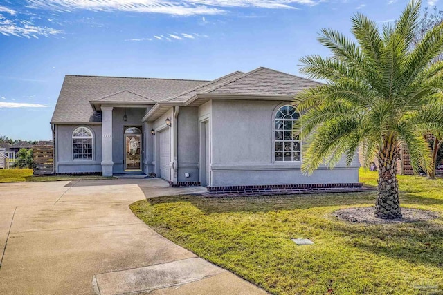 view of front of house featuring a garage and a front lawn