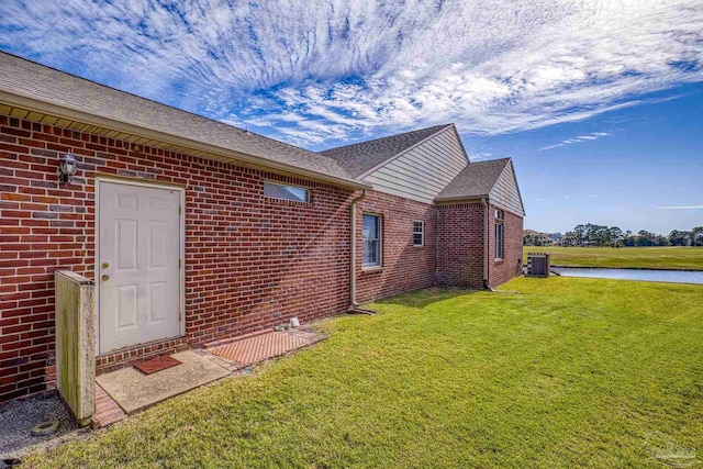 exterior space featuring a yard and a water view