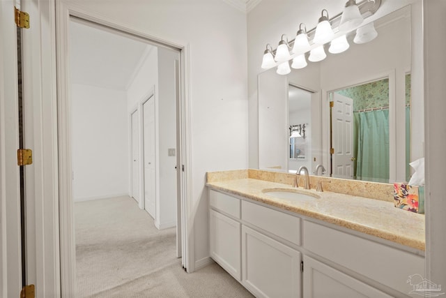 bathroom with walk in shower, crown molding, and vanity