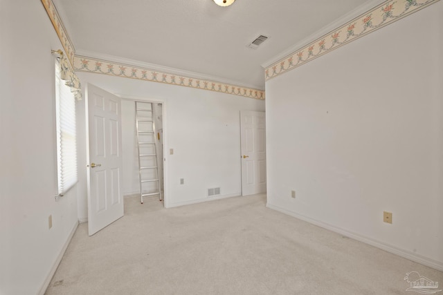 carpeted spare room with crown molding