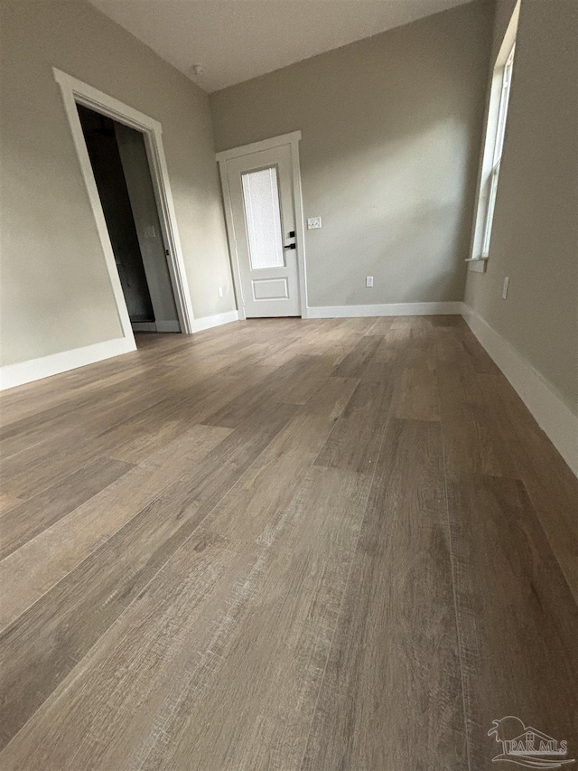 empty room with hardwood / wood-style flooring