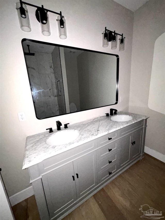 bathroom with vanity, hardwood / wood-style floors, and walk in shower