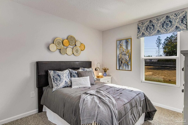 bedroom featuring carpet and a textured ceiling