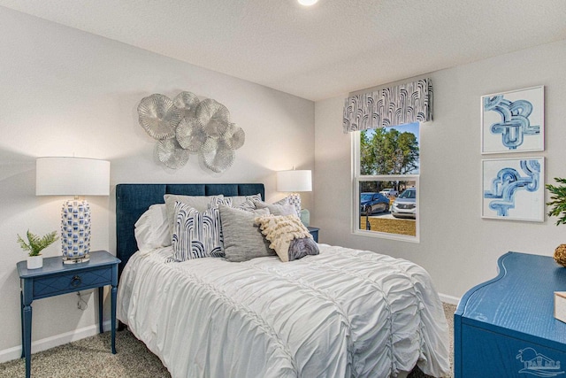 bedroom featuring a textured ceiling and carpet floors