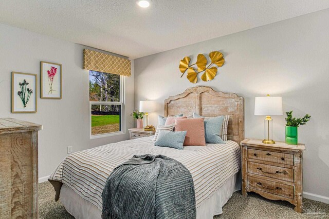 bedroom with carpet flooring and a textured ceiling