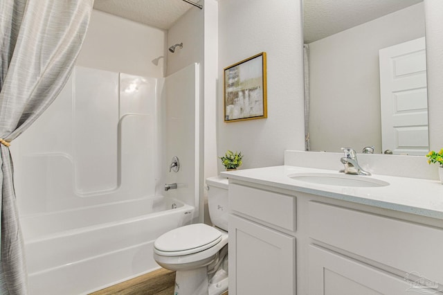 full bathroom featuring shower / bath combo, vanity, a textured ceiling, hardwood / wood-style flooring, and toilet