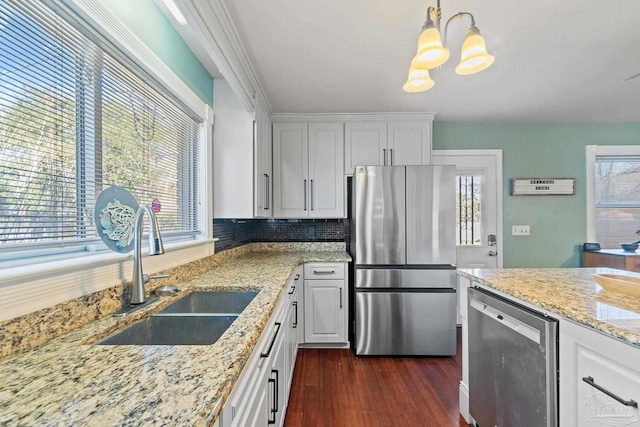 kitchen with white cabinetry, decorative light fixtures, beverage cooler, stainless steel refrigerator, and sink