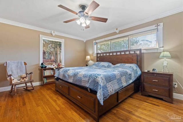 bedroom with ceiling fan, crown molding, and light hardwood / wood-style floors