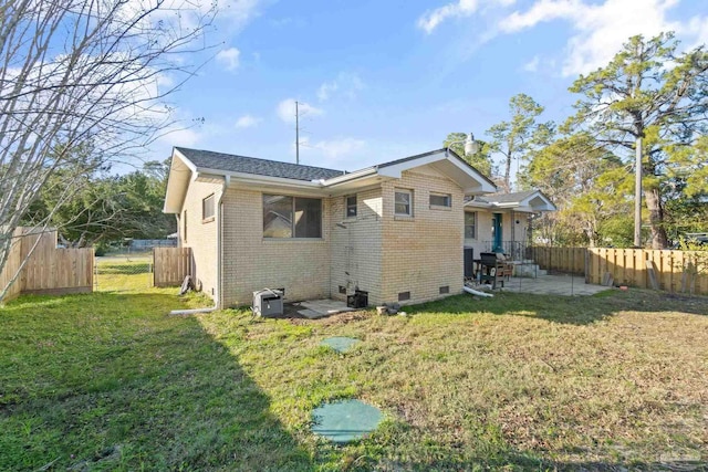 back of house featuring a yard and a patio