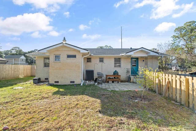 back of house with cooling unit, a patio area, and a yard