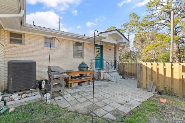 back of house with central AC unit and a patio