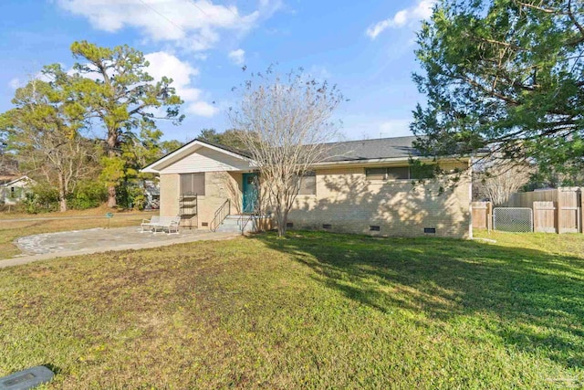 ranch-style house featuring a front lawn and a patio