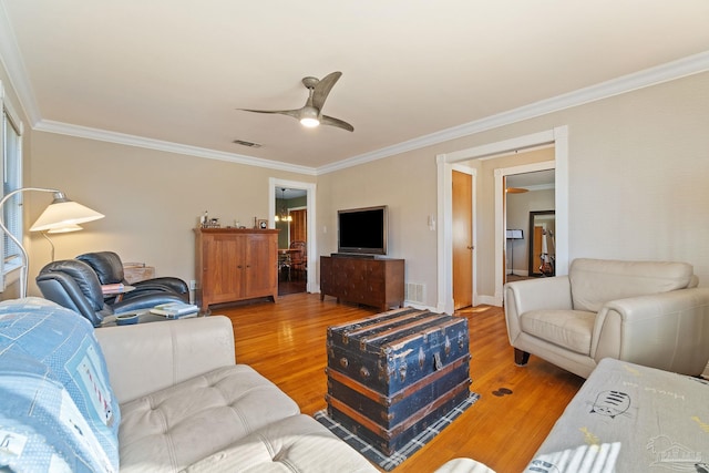 living room with ceiling fan, ornamental molding, and hardwood / wood-style flooring