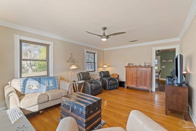 living room with ceiling fan, plenty of natural light, ornamental molding, and hardwood / wood-style floors