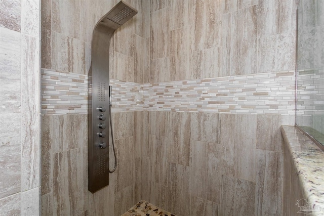 interior details with a tile shower