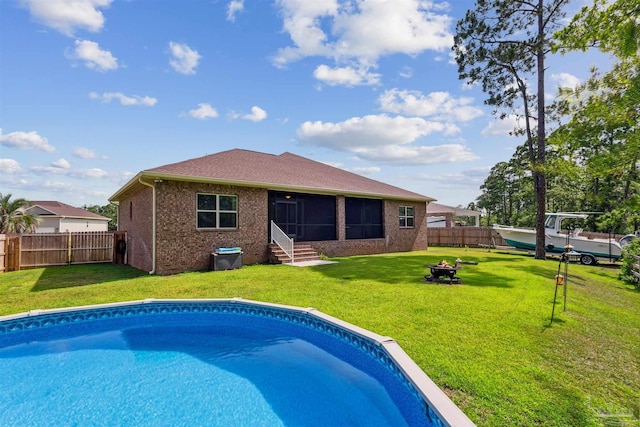 view of pool with a yard and a sunroom