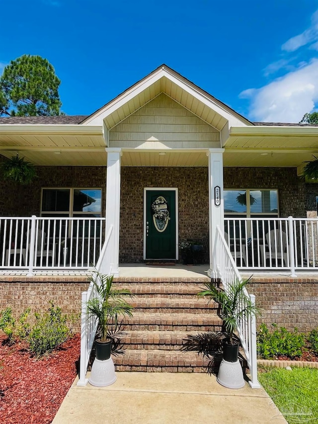 view of exterior entry with a porch