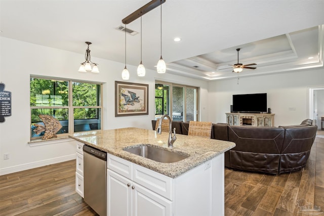 kitchen featuring white cabinets, hanging light fixtures, ceiling fan with notable chandelier, sink, and stainless steel dishwasher