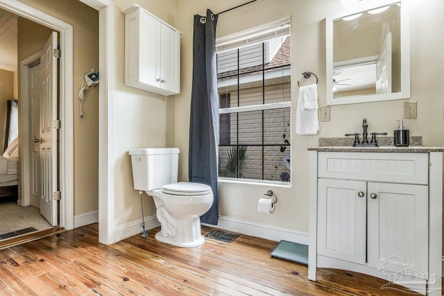 bathroom featuring hardwood / wood-style floors, toilet, and vanity