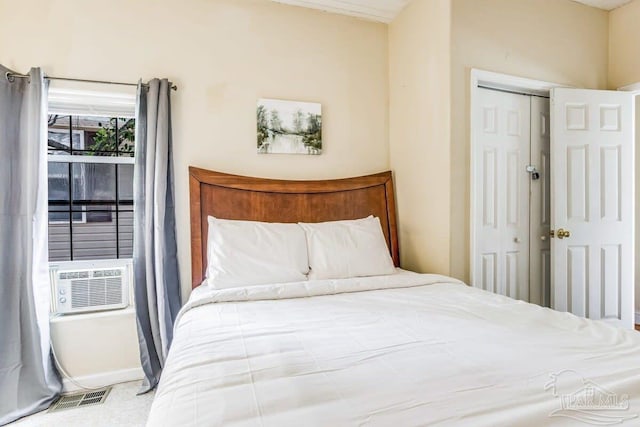 carpeted bedroom featuring cooling unit and a closet