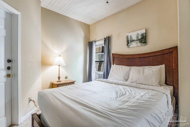 carpeted bedroom with wooden ceiling